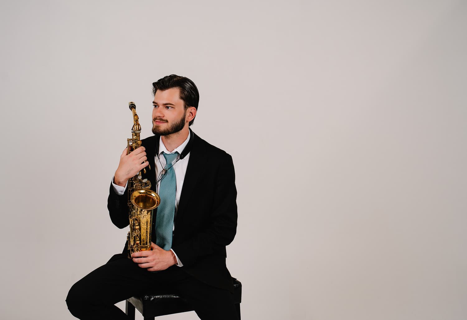 Dalton Stanland seated with his alto saxophone